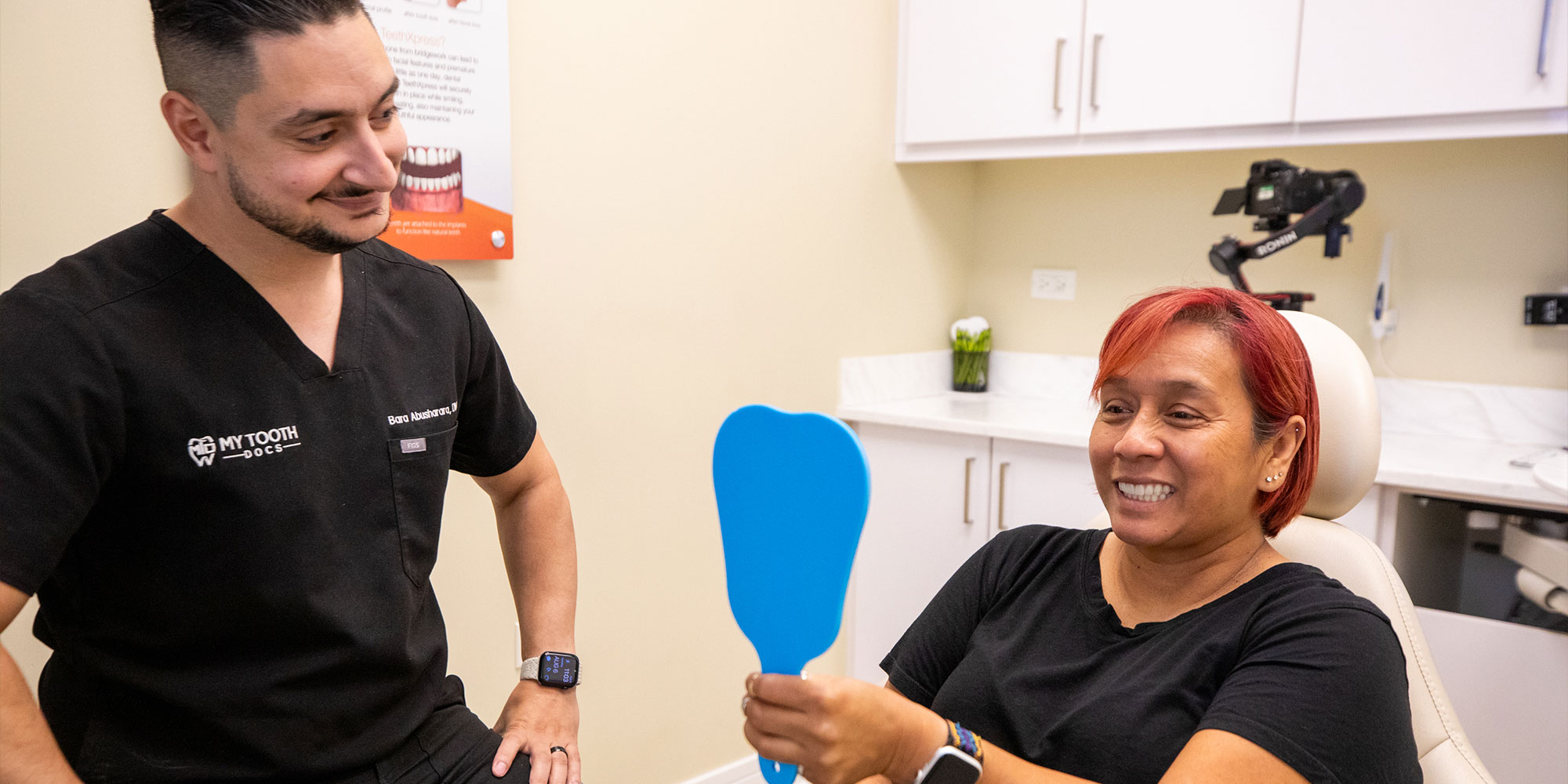 dentist showing patient teeth after whitening