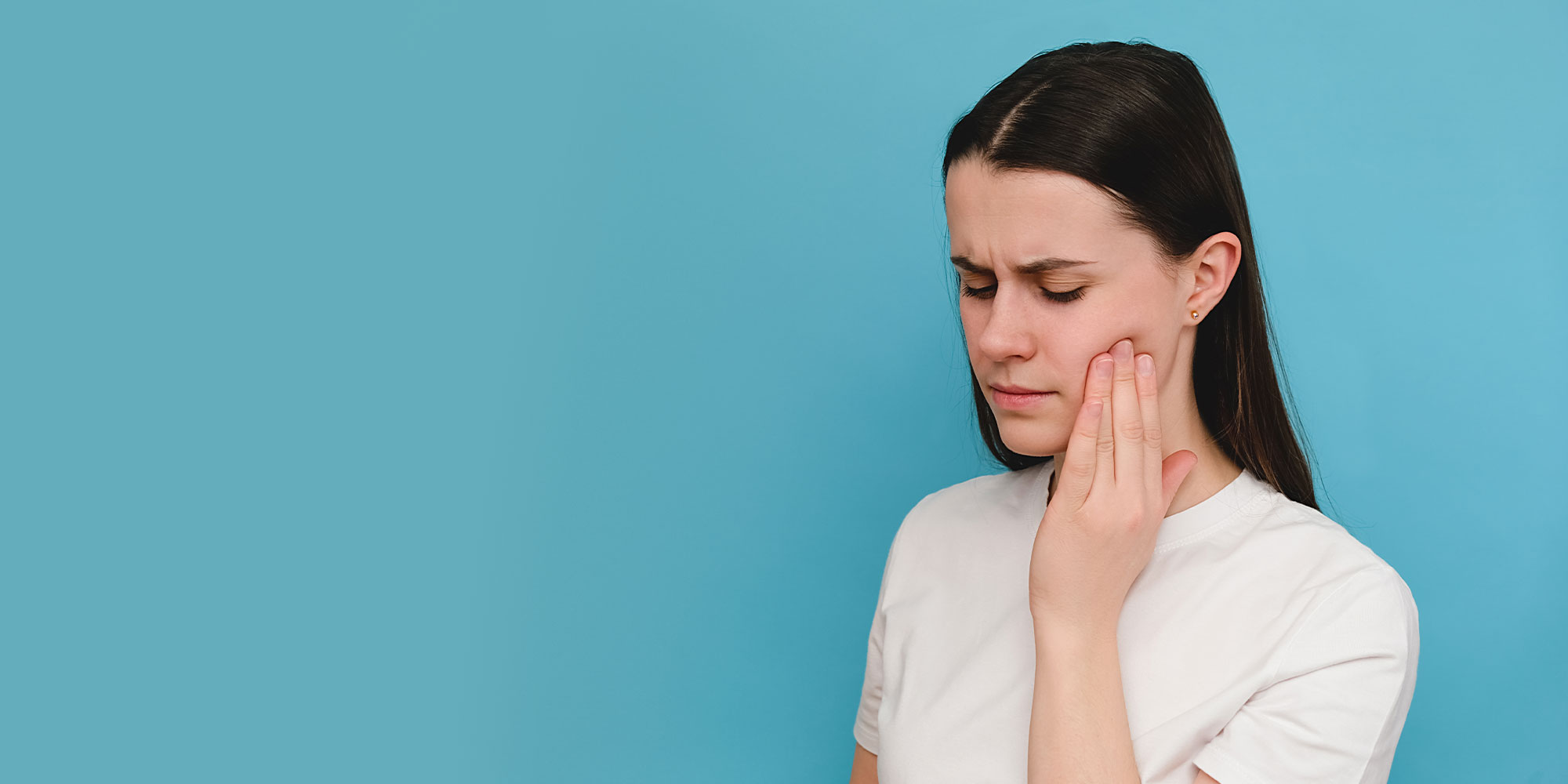 patient holding mouth in pain