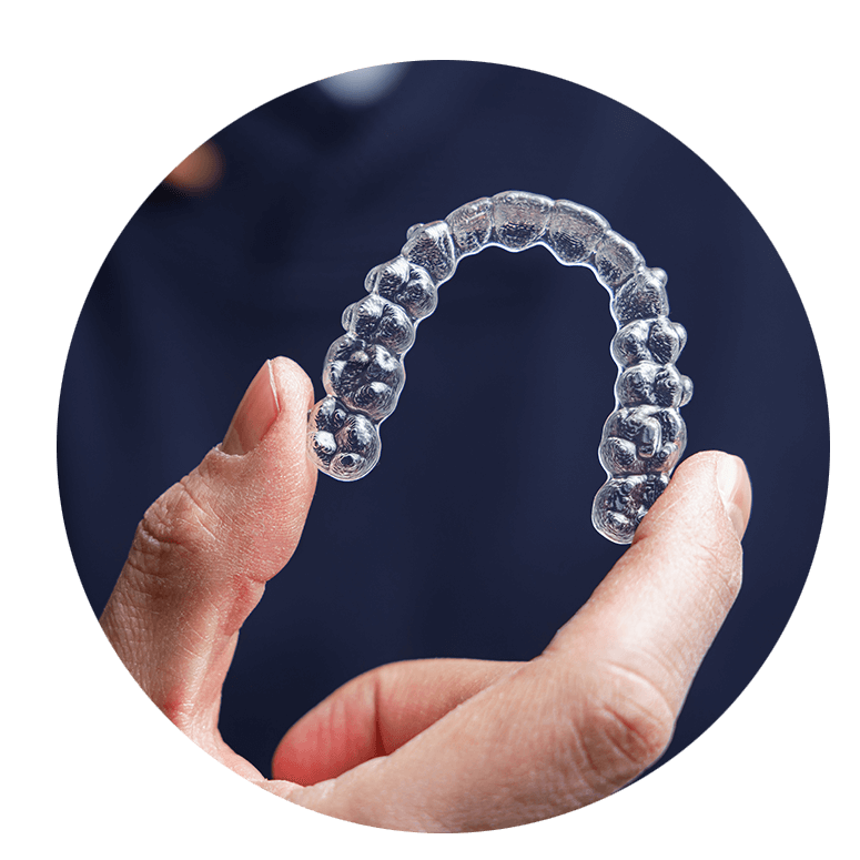 hand holding up invisalign
