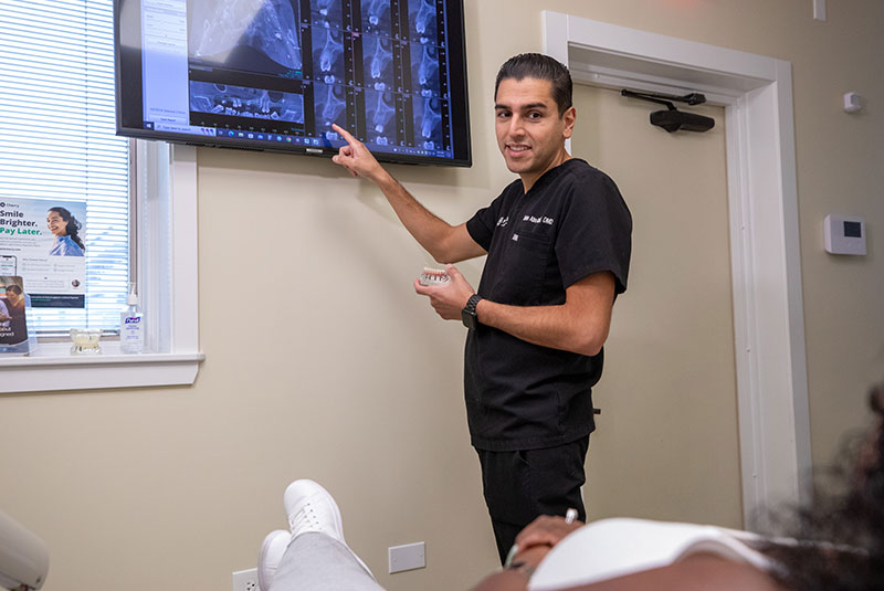 dentist pointing to x-rays